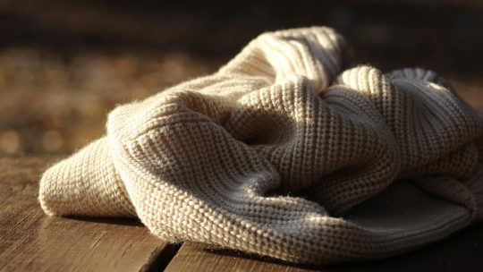 a white scarf on a wooden floor