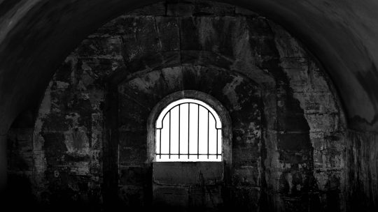 the window of a stone jail cell